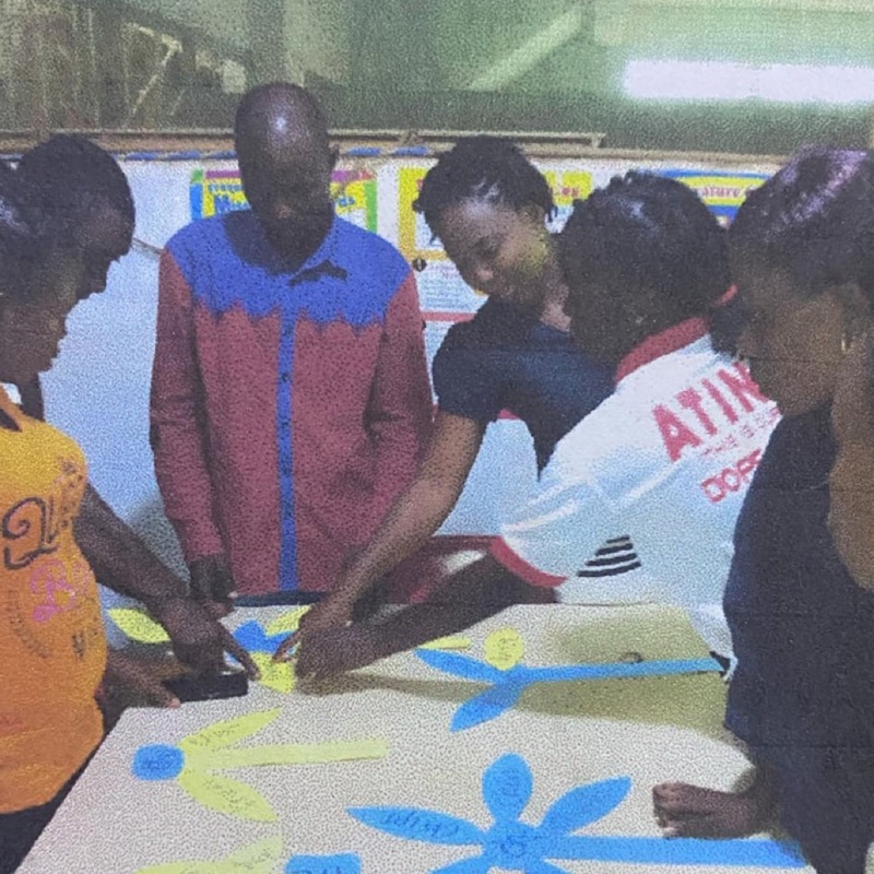 Teachers and trainees working together around a table of phonics teaching materials